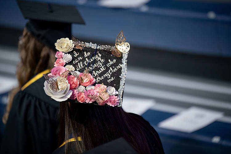 a student wears a hat that says i can do all things through christ who strengthens me