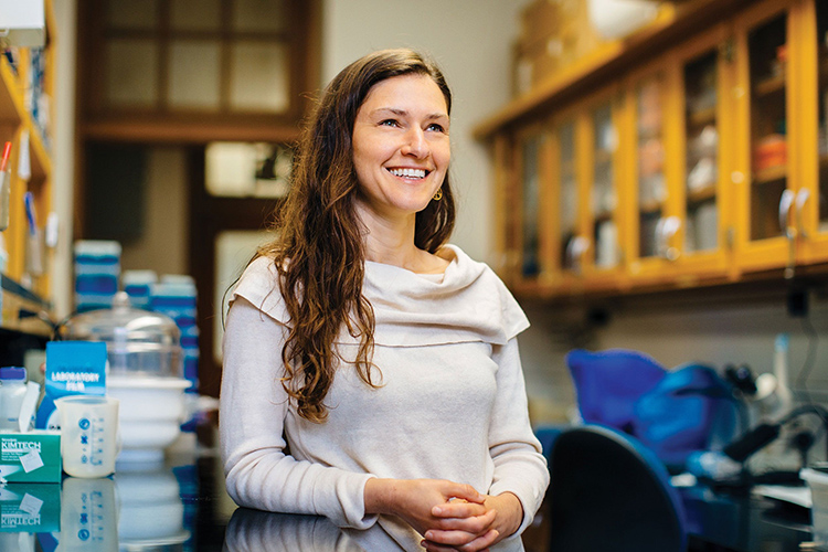 Professor Erica Rosenblum, faculty director of the Berkeley Discovery Initiative, smiles and looks into the distance in a campus science lab.