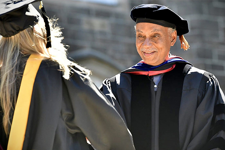 Tyler Stovall smiling at a graduation ceremony