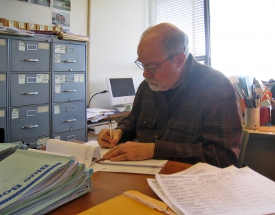 Paul Groth writing at his desk.