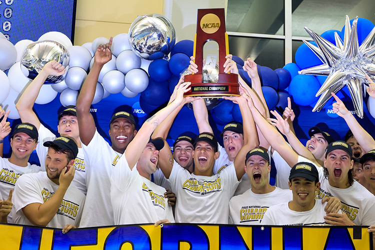 Cal men's team holding up NCAA championship trophy