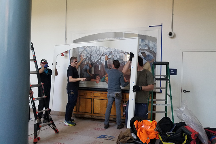 Workers helping to restore the fresco