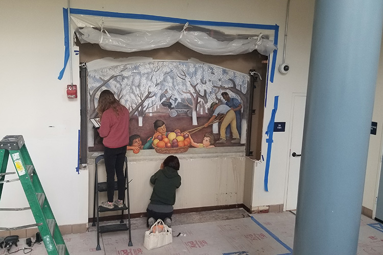 People restoring a fresco