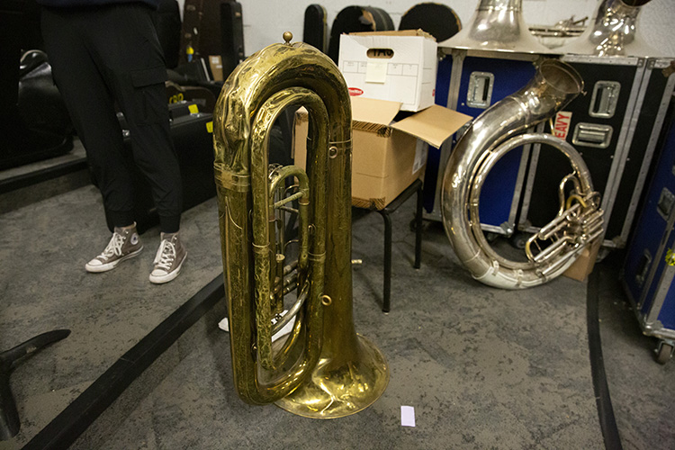 A dented brass tuba sits in the Cal Band's practice room.