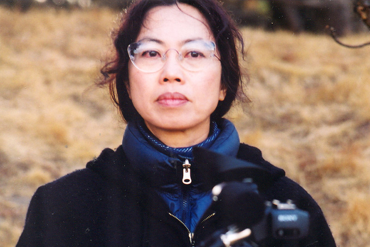 portrait of a person outside with a camera