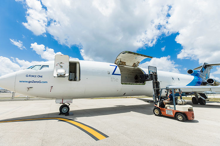 A photo of a white airplane parked on the tarmac