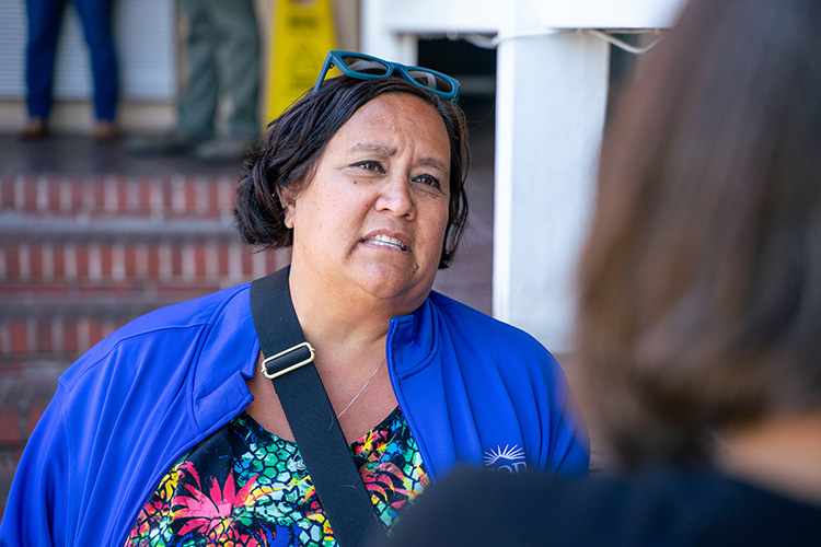 A close-up photo of Kara Carnahan, the vice president of programming for Abode Services, the nonprofit that's running the program at the Rodeway Inn in Berkeley for former residents of People's Park. She's wearing a royal blue jacket with the Abode Services logo on it.