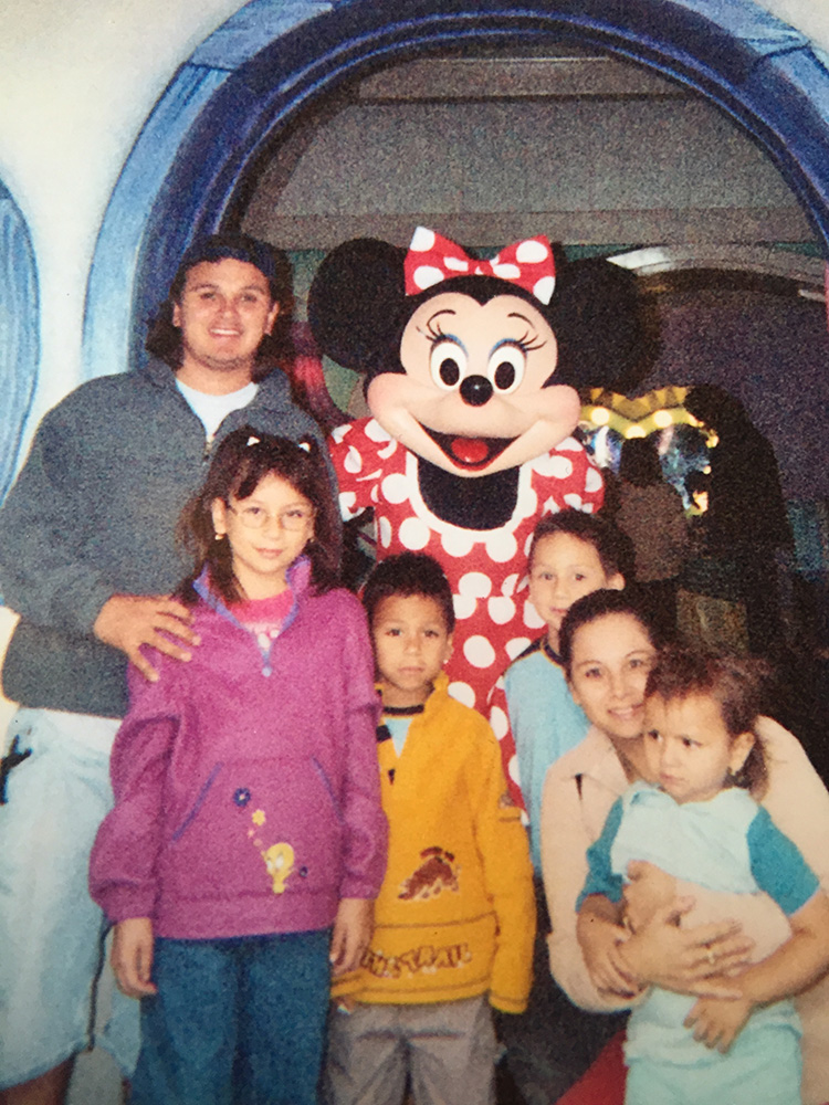 Childhood photo of Ibarra’s family at Disneyland. From left to right: father, older sister Kelly, twin brother Carlos, mother, and younger sister Karla.
