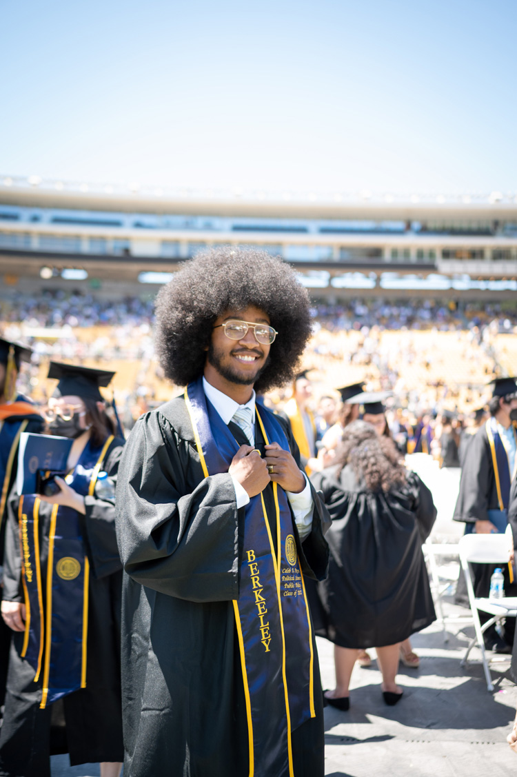 a student celebrates on the field of memorial stadium