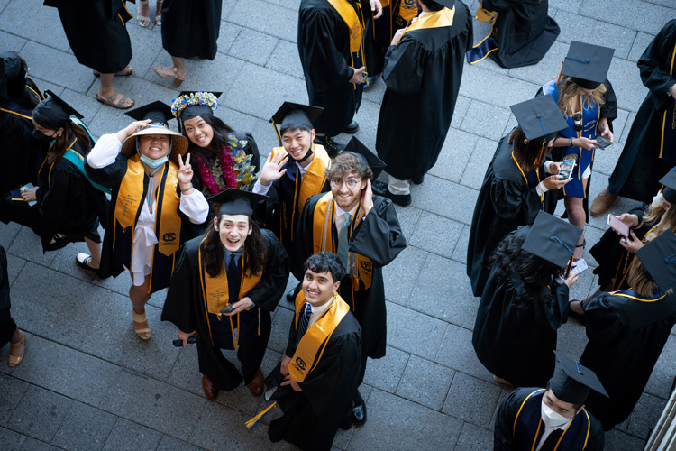 student celebrate their graduation outside of memorial stadium