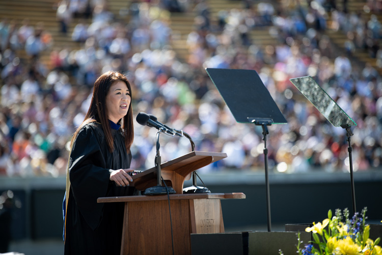 sunny lee talks to graduates at a podium