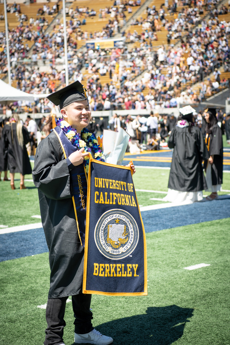 a student holds a sign that says university of california berkeley