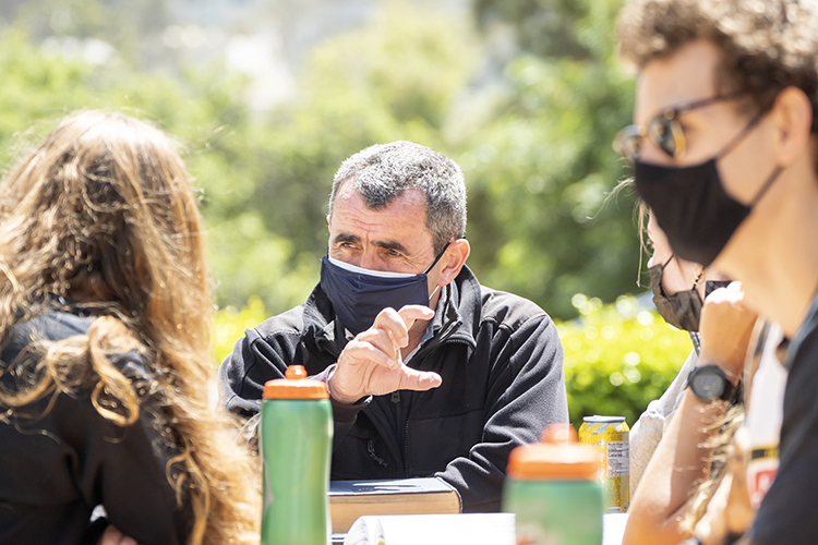 Wearing a mask, like his students, professor Oliver O'Reilly talks with his class outdoors during his spring 2021 freshman seminar, Bears in Boats: A History of Women and Men's Rowing at the University of California, Berkeley.