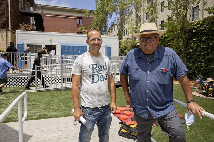 Ari Neulight, left, and Ruben Lizardo stand for a portrait at the newly opened Sacred Rest Drop-In Center in Berkeley, Calif. on Wednesday, June 22, 2022.