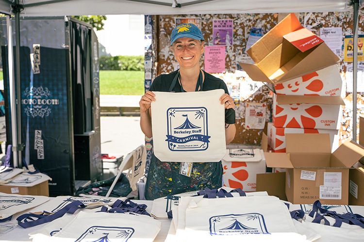 Ariel Berson (ASUC Student Union) models the tote bags that her team was screen printing on demand.