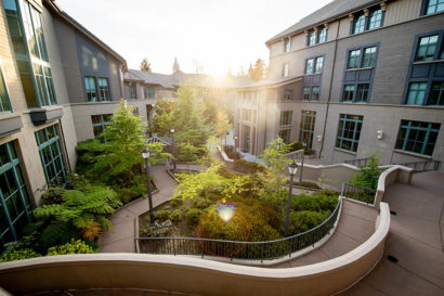 the sun shines through the arch at the Haas School of Business