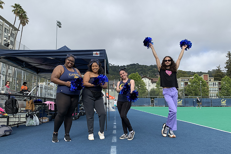 The Residential Life softball team's cheer squad waves their pom-pom at a recent game.