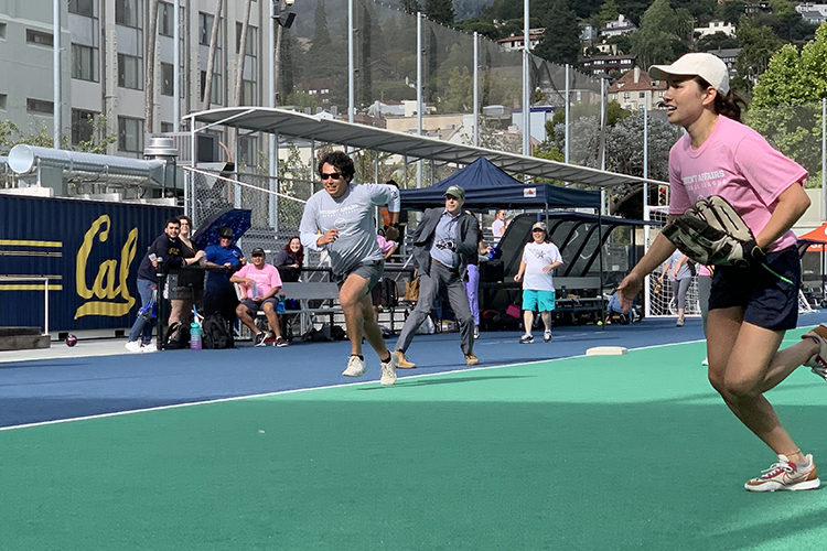 A softball game is underway on the field above the Underhill parking structure.