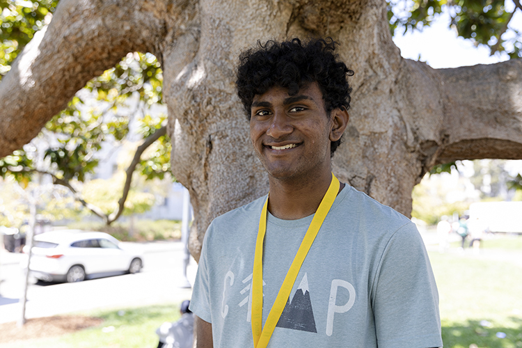 portrait of a person smiling outside by a tree