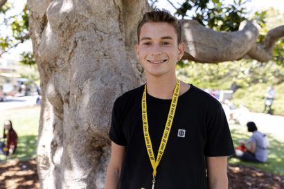 person standing outside smiles at the camera
