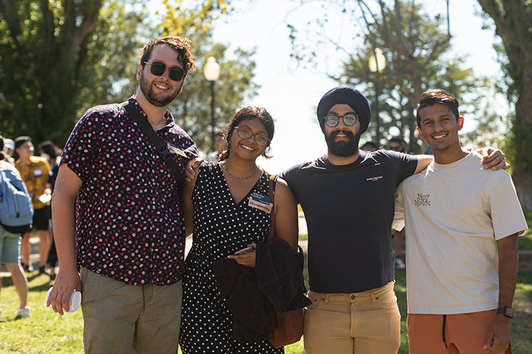 Students at an orientation event for the Fung Institute for Engineering Leadership pose for a photo. There are four students with their arms around each other.