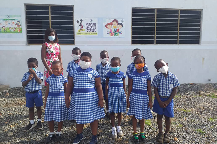 School children in Ghana pose for a photo outside the school that Berkeley graduates Vicentia Gyau and Abraham Martey opened.