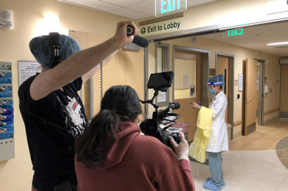 Two students filing a doctor in a hospital.