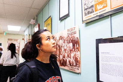 Nina Sanchez viewing a museum exhibit at the Ethnic Studies Library.