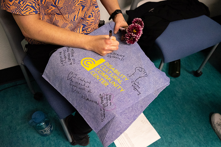 DCC Center bag being signed by panelists