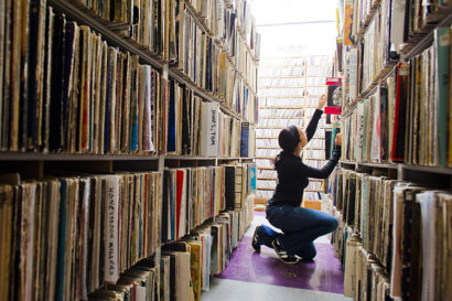 A student in a campus library looks for a selection in the stacks.