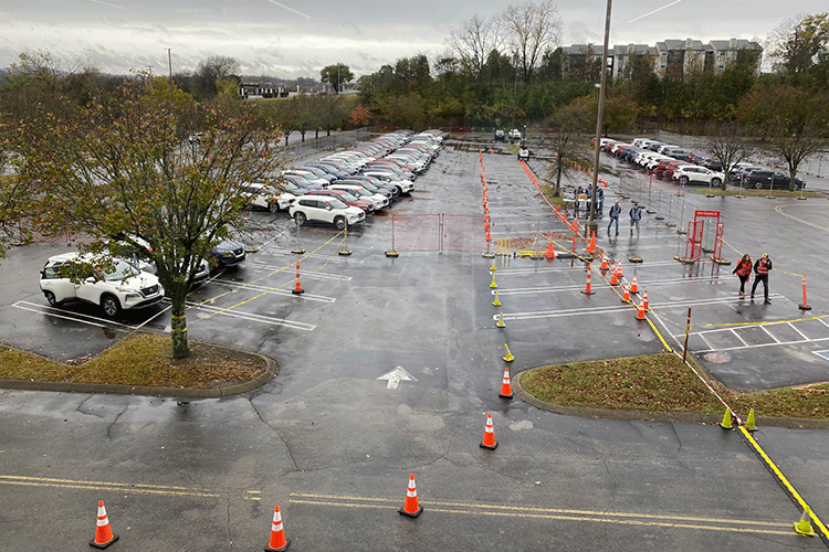 A photo shows a full parking lot on a rainy day