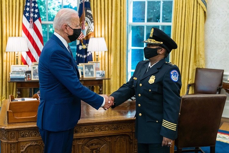 President Joe Biden, left, shakes hands with Yogananda Pittman, the acting chief of the U.S. Capitol Police Force in the White House Oval Office