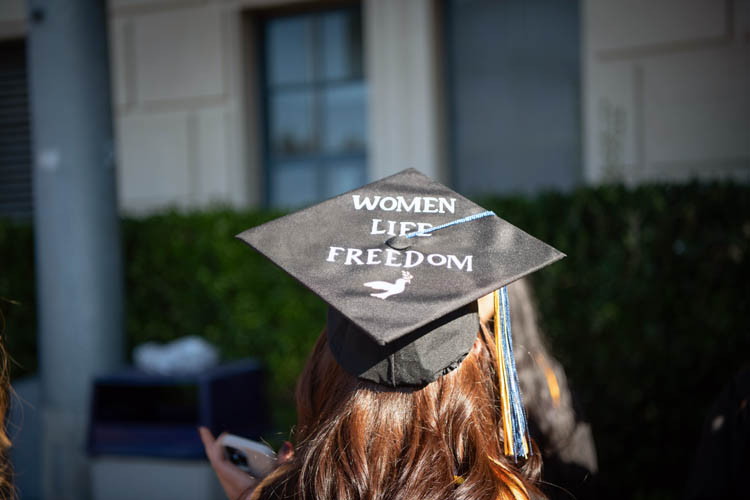 a grad cap that says women, life, freedom
