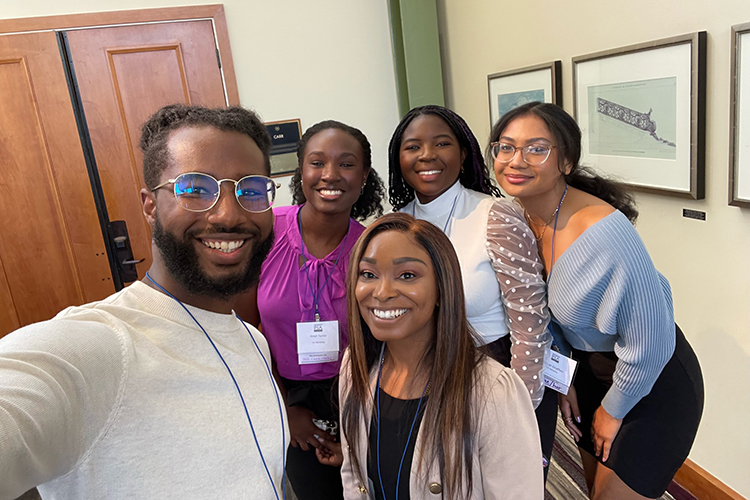 Caleb Dawson posing with undergrad students from BLAC