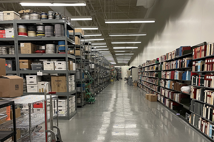 The BAMPFA film vault is a large industrial space that's likely the size of a football field, with rows of shelving and thousands of film cans.