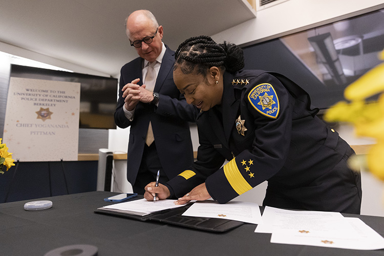 Berkeley's new police chief signs a copy of her oath at the Feb. 1 ceremony.