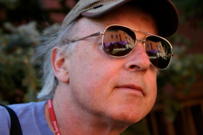 a person wearing sunglasses looks into the distance