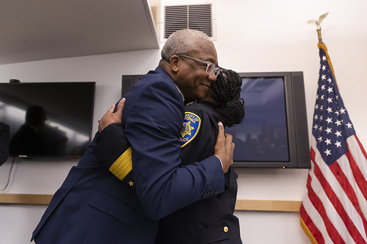 New police chief Yogananda Pittman and her husband embrace at her swearing-in ceremony.