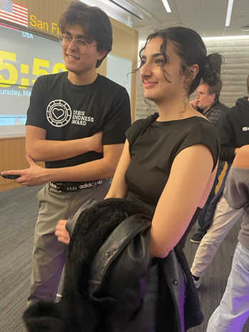 Egbert Villegas and Nelly Elahmadie, two UC Berkeley students, talk with friends and fellow students at the Chris Kindness Award ceremony at Berkeley Haas, where Villegas won an award for a random act of kindness.