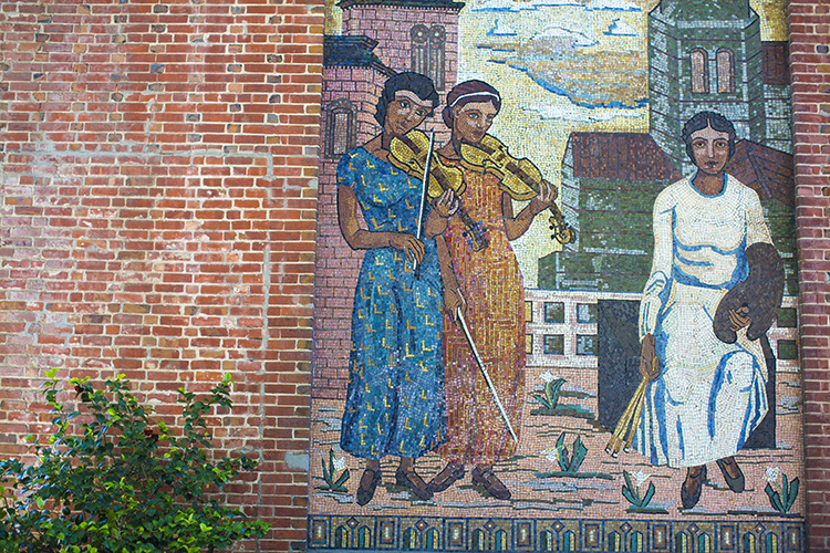 This colorful mosaic mural on the Old Art Gallery building depicts two women with violins and another with paint brushes and an artist's palette.