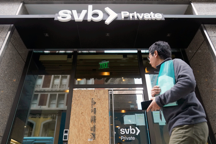 A pedestrian passes a closed Silicon Valley Bank branch in San Francisco on Monday, March 13, 2023. (AP Photo/Jeff Chiu)