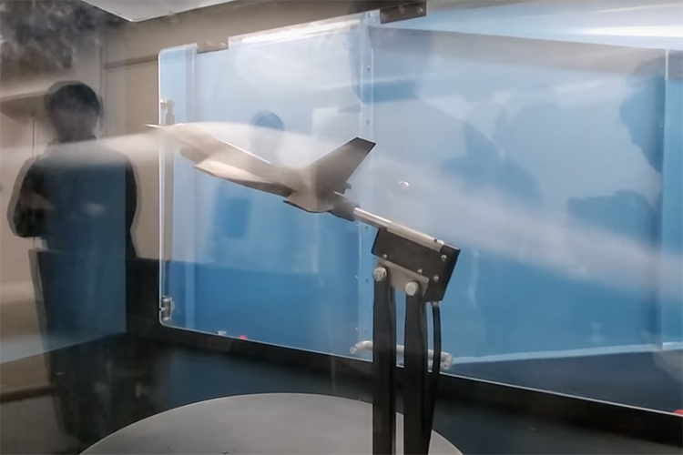 a model of plane going through a slip steam of air in a wind tunnel