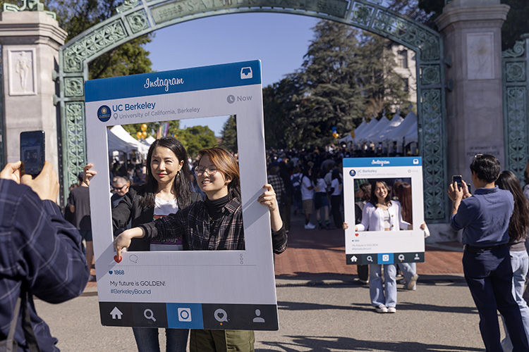 Students and their parents pose in instagram frames