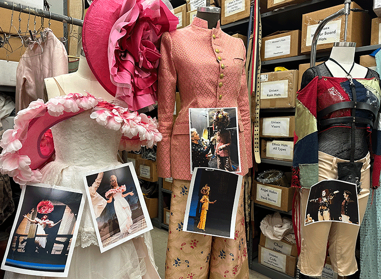 A photo shows three colorful costumes that have been hung on mannequins for display, along with photos of the dramatic production that each costume appeared in.