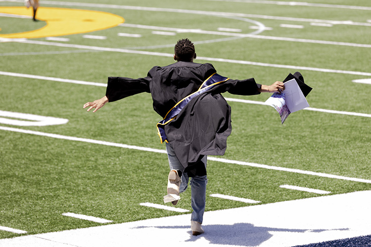 A student running across field.