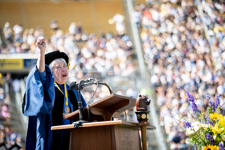 Chancellor Carol Christ salutes the commencement crowd during her speech with a 