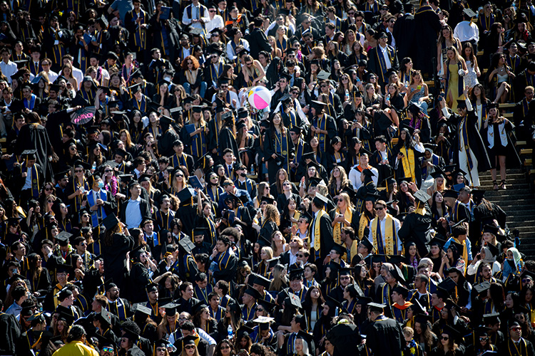 A beach ball as batted around the crowd of graduates at Memorial Stadium at Saturday's commencement ceremony.