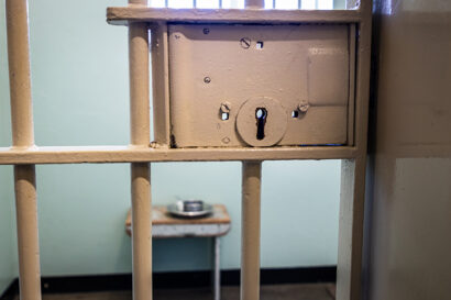 beige-colored bars looking into a jail cell