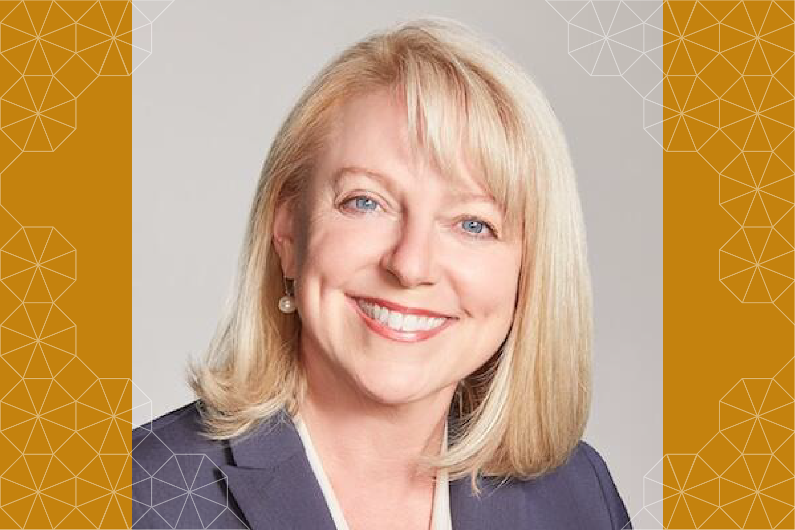 A headshot of Michelle Young smiling surrounded by a tessellated pattern