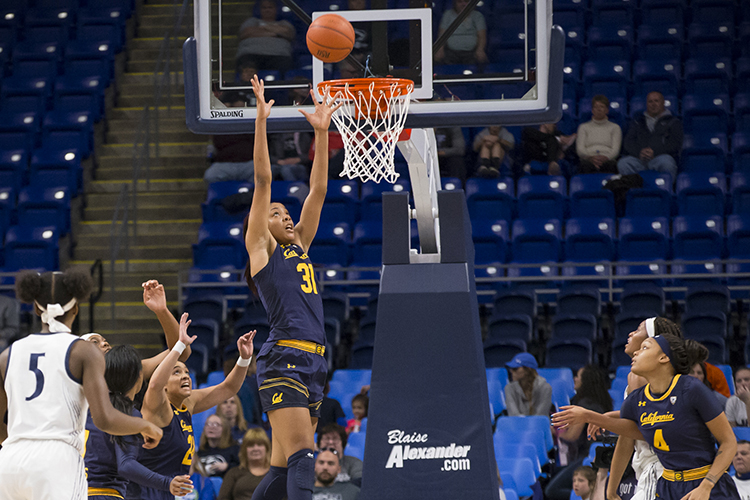 Cal Basketball player Kristine Anigwe shoots a basket during a game